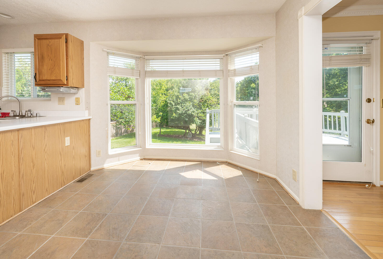 2 Laurel Ridge Drive Alexandria, KY 41001 - Photo 9 of 37 Bay window with multiple panes, tile flooring, wood-finish cabinetry, white countertops, and a full-light door providing exterior access