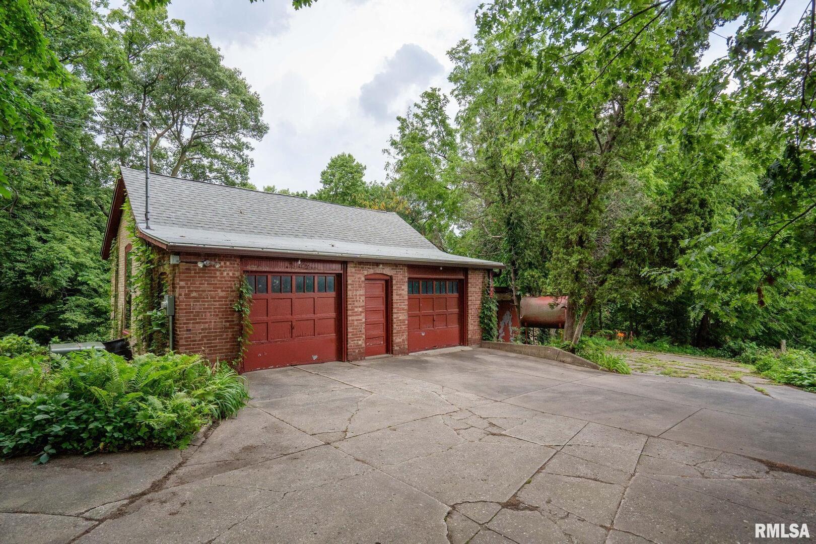 5418 Chapel Hill Road Davenport, IA 52802 - Photo 20 of 69 a front view of a house with a yard and garage