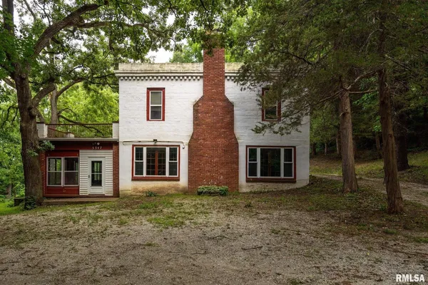 a view of an empty room with window and fireplace