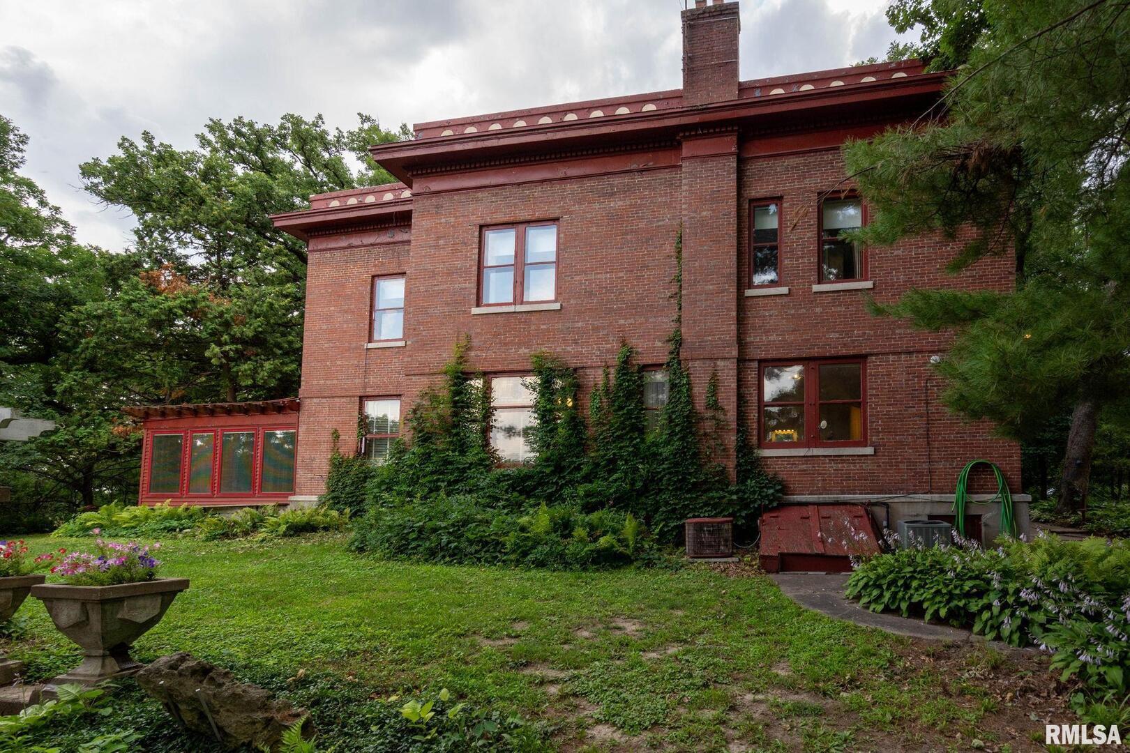 5418 Chapel Hill Road Davenport, IA 52802 - Photo 27 of 69 a view of a brick house with a yard