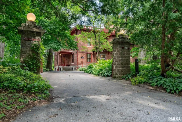 a front view of a house with a yard and a garden