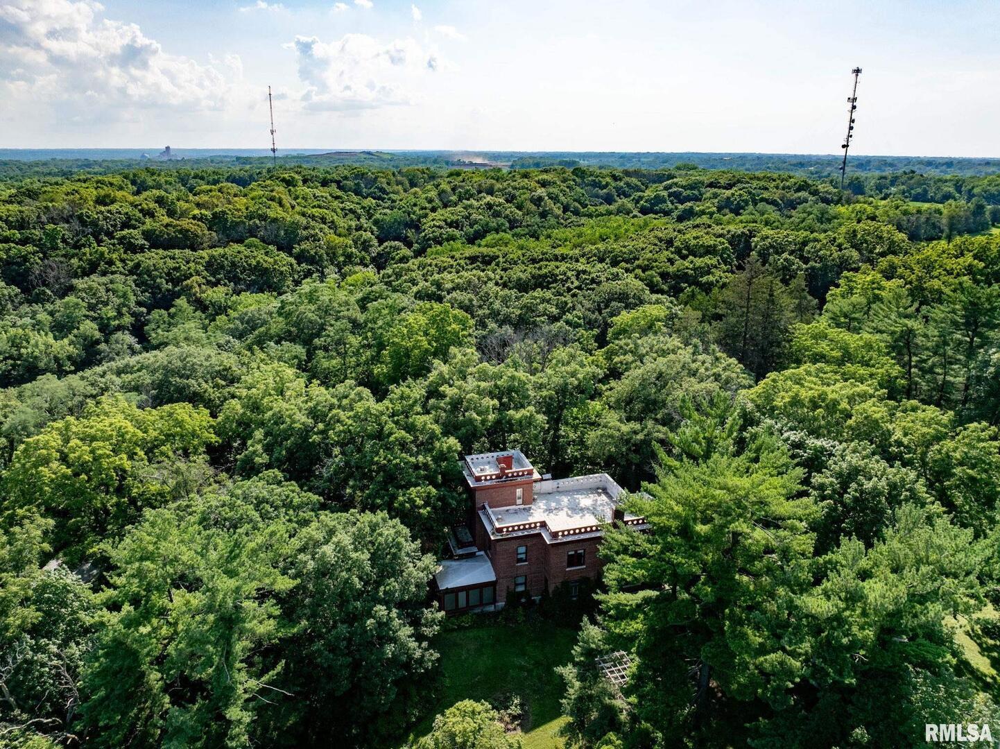 5418 Chapel Hill Road Davenport, IA 52802 - Photo 38 of 69 a view of a garden with a bench sitting in middle of the green field