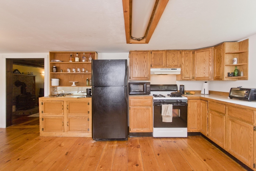 386 Main Road Chesterfield, MA 01012 - Photo 5 of 37 a kitchen with stainless steel appliances granite countertop a refrigerator and a stove top oven