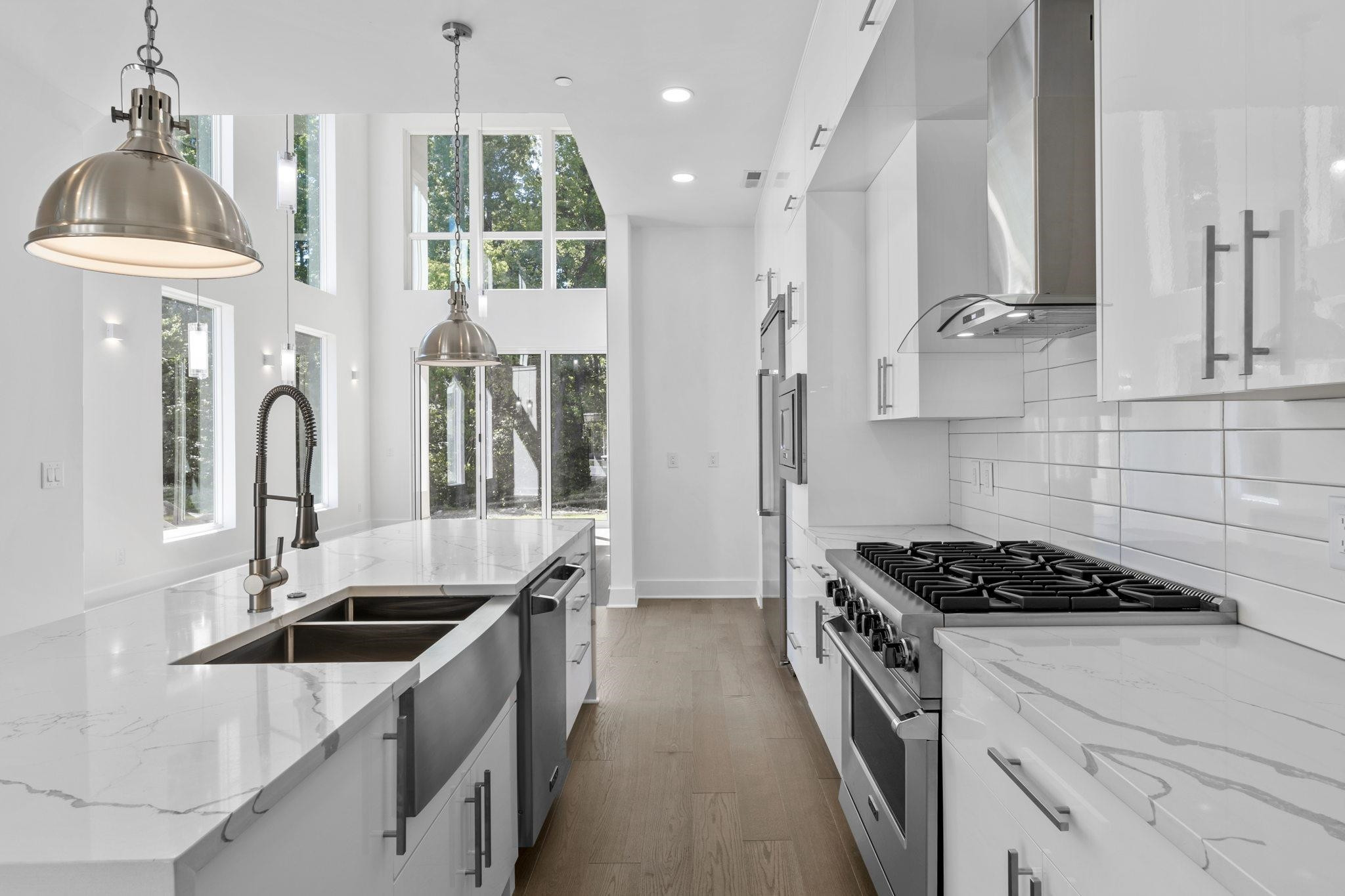 a kitchen that has a sink stainless steel appliances a counter space and a window