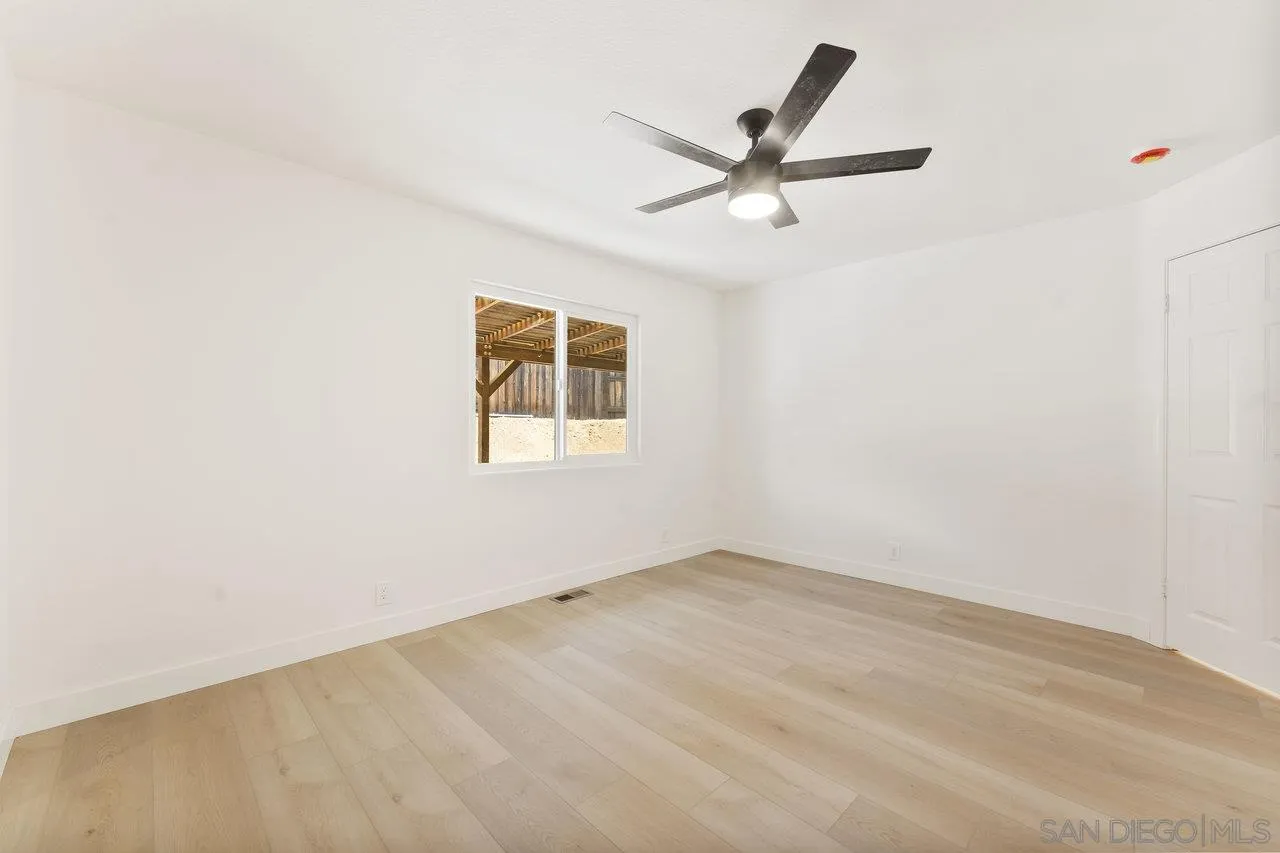 2047 Via Del Torrie Alpine, CA 91901 - Photo 21 of 53 an empty room with a window and a fan