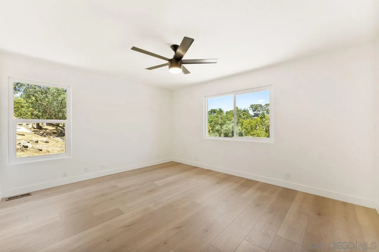 2047 Via Del Torrie Alpine, CA 91901 - Photo 23 of 53 an empty room with windows and ceiling fan