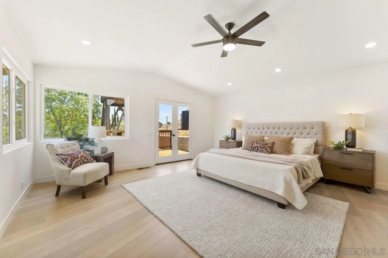 2047 Via Del Torrie Alpine, CA 91901 - Photo 28 of 53 a spacious bedroom with a bed a couch and a window