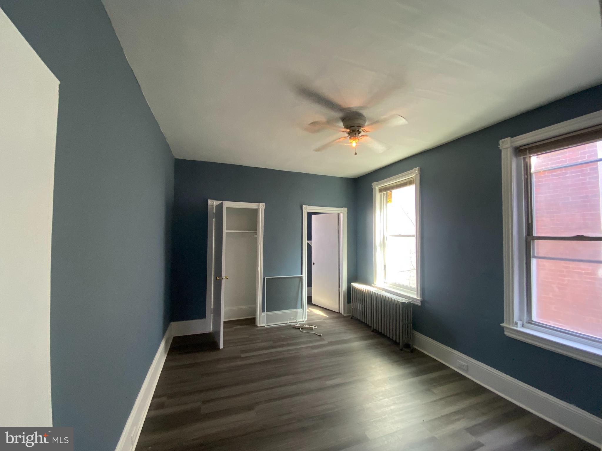 6625 Lansdowne Avenue, Unit 2 Philadelphia, PA 19151 - Photo 4 of 6 an empty room with wooden floor and windows