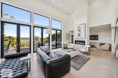 a view of a patio with couches and table with wooden floor and fence