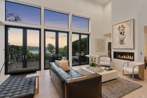 a living room with furniture and a floor to ceiling window