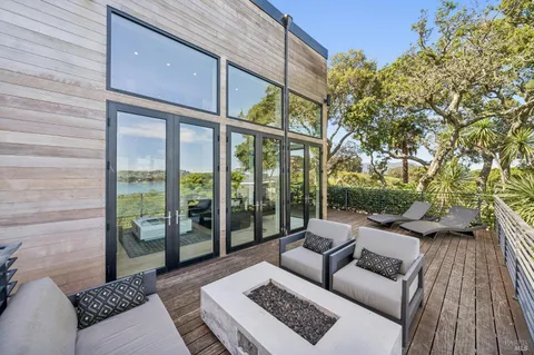 a view of a hallway with wooden floor and furniture