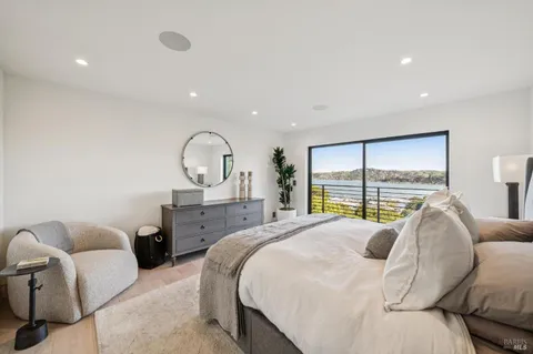 a view of a roof deck with couches and wooden floor