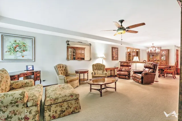a living room with furniture ceiling fan and a window