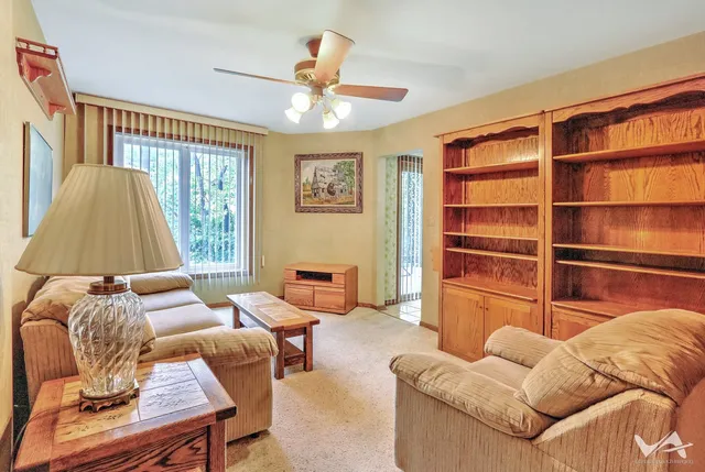 a view of a chairs and table in patio with a backyard