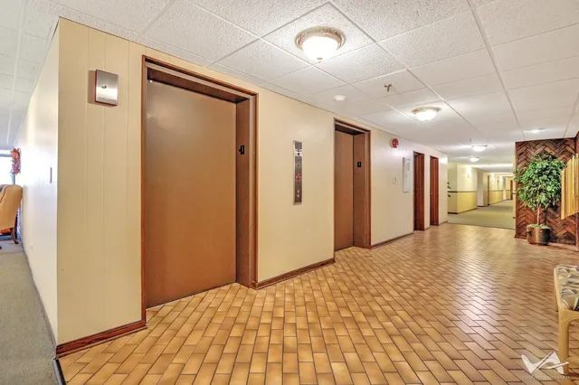 a dining room with furniture a chandelier and a rug