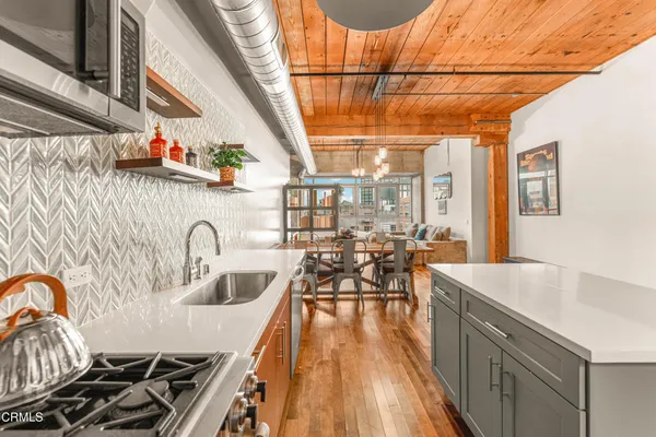 a kitchen with sink a stove and cabinets