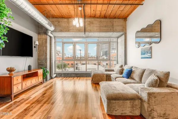 a bedroom with furniture and a flat screen tv
