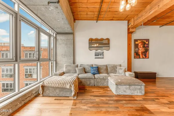 a living room with furniture and a floor to ceiling window