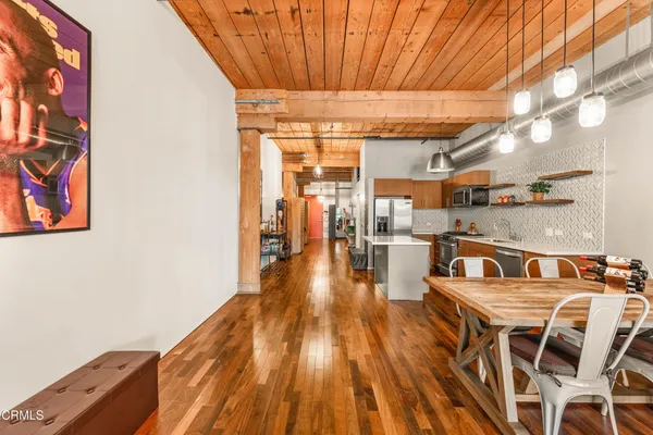 a dining room with furniture and wooden floor