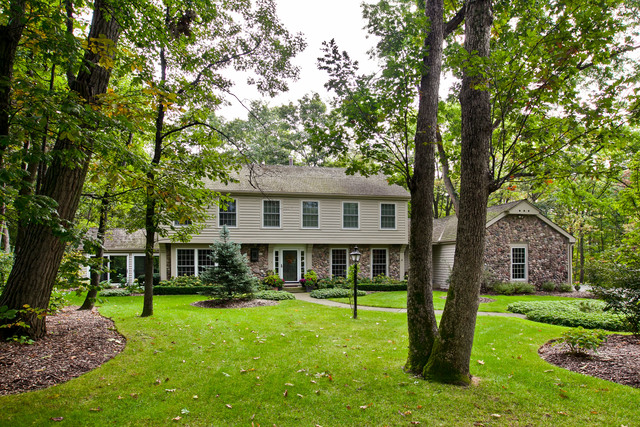 a front view of a house with a yard table and chairs