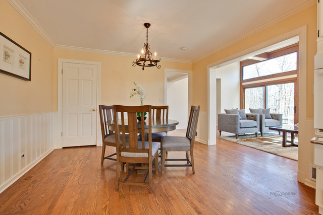 721 Rockefeller Road Lake Forest, IL 60045 - Photo 15 of 25 a view of a dining room with furniture window and wooden floor