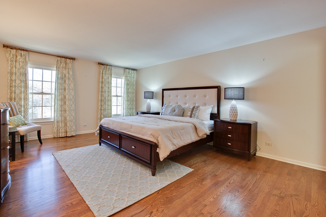 721 Rockefeller Road Lake Forest, IL 60045 - Photo 16 of 25 a spacious bedroom with a bed and wooden floor
