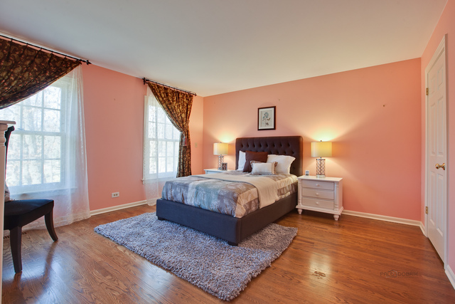 721 Rockefeller Road Lake Forest, IL 60045 - Photo 21 of 25 a bedroom with a large bed and wooden floor