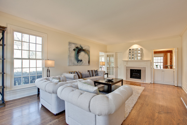721 Rockefeller Road Lake Forest, IL 60045 - Photo 3 of 25 a living room with furniture a fireplace and a large window