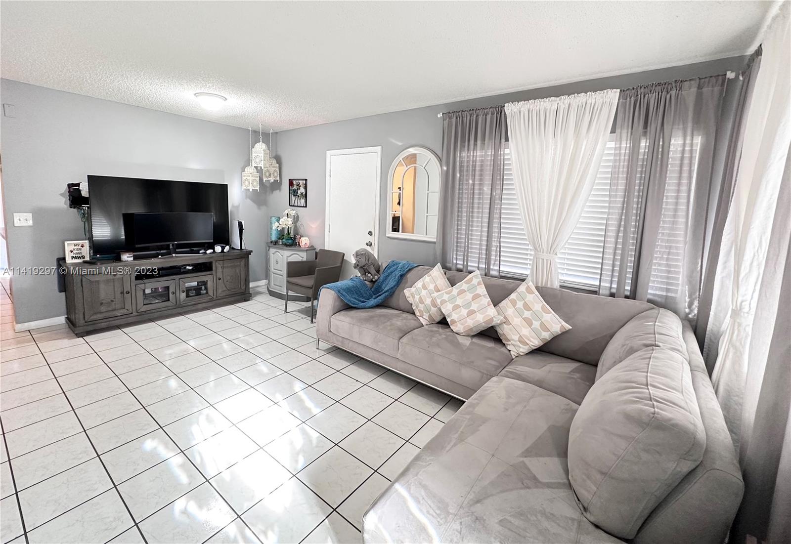West Perrine Miami, FL 33157 - Photo 2 of 7 a living room with furniture and a flat screen tv