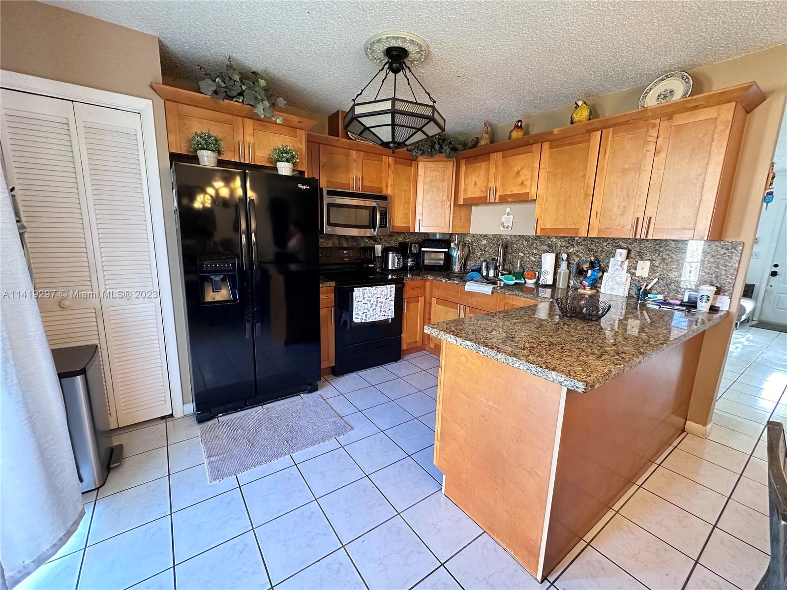 West Perrine Miami, FL 33157 - Photo 3 of 7 a kitchen with stainless steel appliances granite countertop a refrigerator a stove and a sink