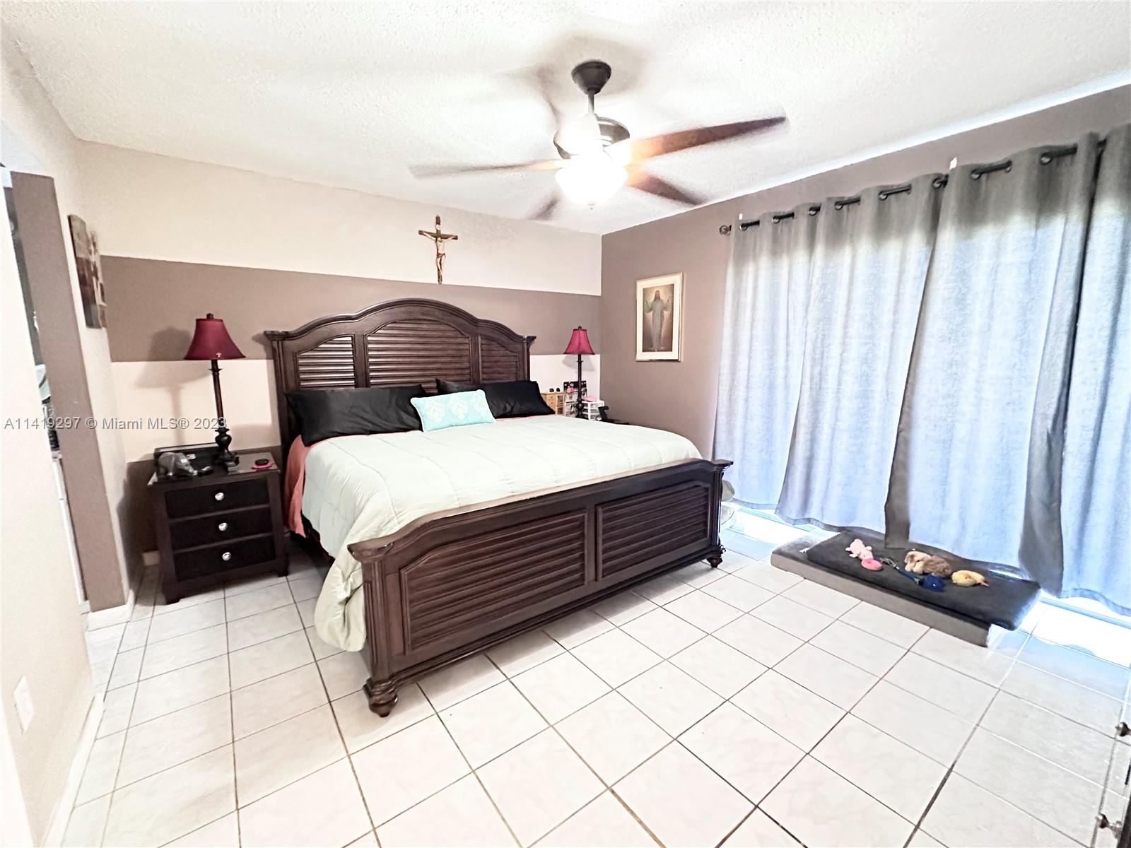 West Perrine Miami, FL 33157 - Photo 4 of 7 a bedroom with a bed and a walk in closet