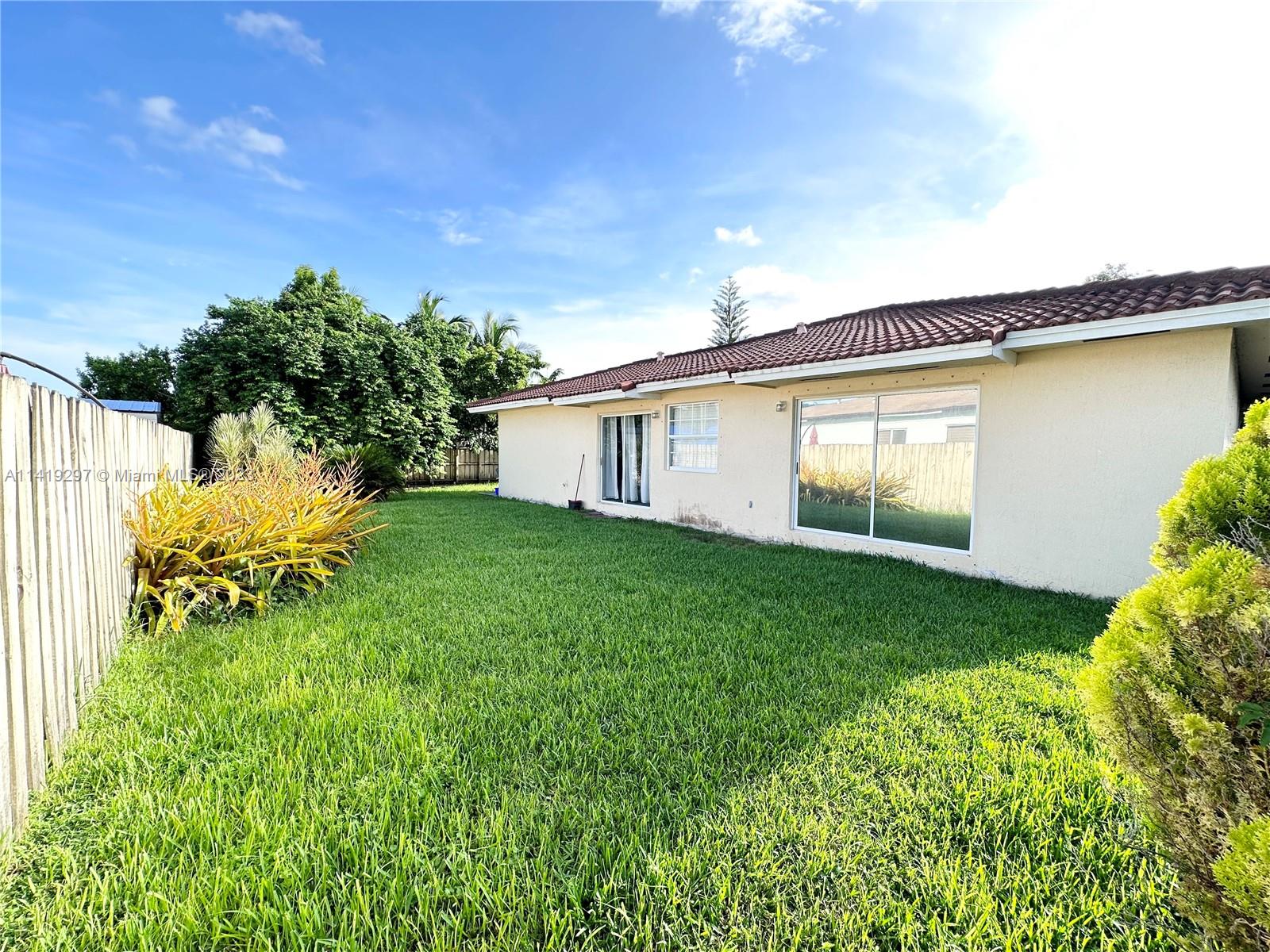 West Perrine Miami, FL 33157 - Photo 6 of 7 a view of a backyard with plants and a garden