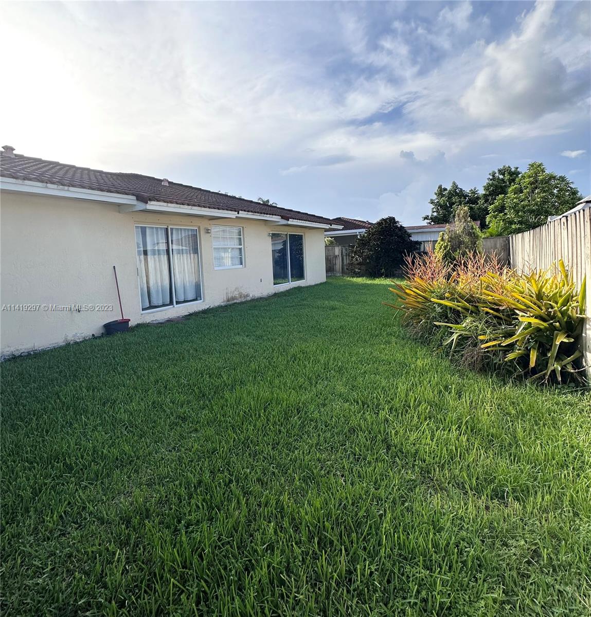 West Perrine Miami, FL 33157 - Photo 7 of 7 a backyard of a house with plants and large tree