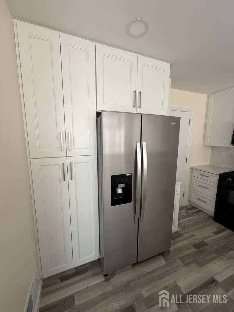 126 Winchester Way Somerset, NJ 08873 - Photo 13 of 33 a view of a refrigerator in kitchen and white cabinets