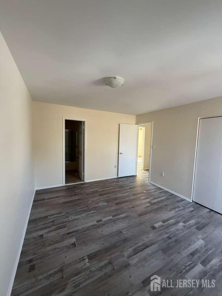 126 Winchester Way Somerset, NJ 08873 - Photo 19 of 33 a view of an empty room with wooden floor and a window