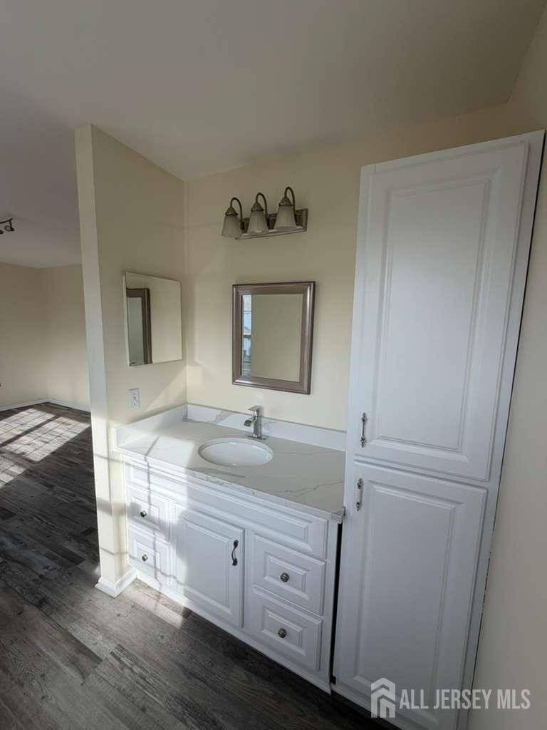 126 Winchester Way Somerset, NJ 08873 - Photo 26 of 33 a bathroom with a sink and a mirror