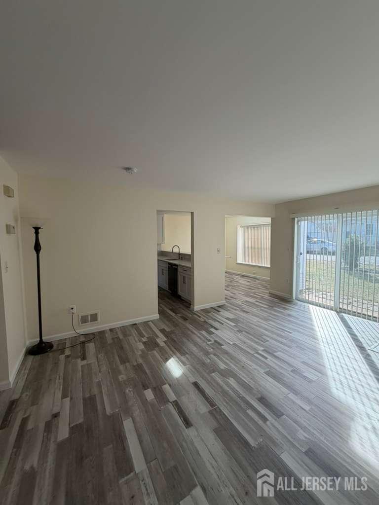 126 Winchester Way Somerset, NJ 08873 - Photo 3 of 33 a view of empty room with wooden floor and window