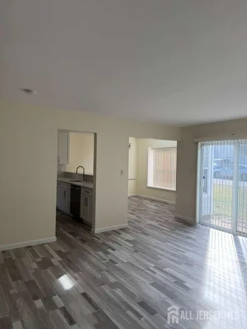 a view of empty room with wooden floor and cabinet