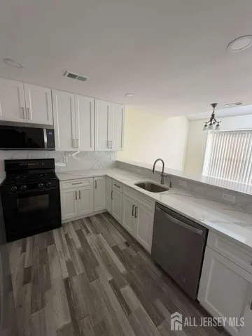 a kitchen with sink and cabinets