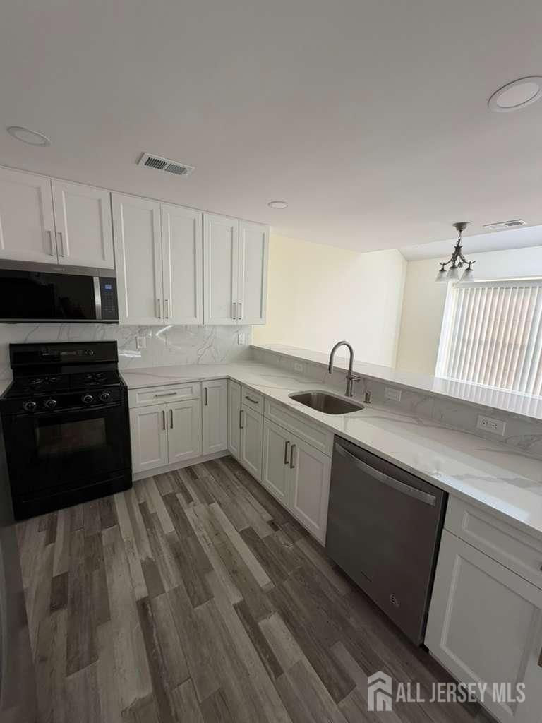 126 Winchester Way Somerset, NJ 08873 - Photo 9 of 33 a kitchen with sink and cabinets