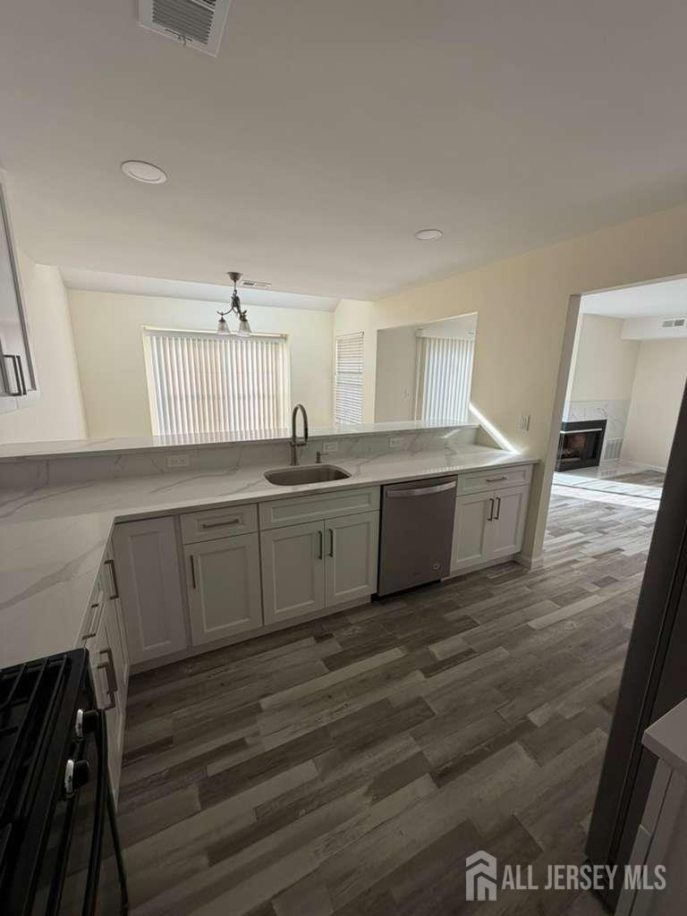 126 Winchester Way Somerset, NJ 08873 - Photo 10 of 33 a kitchen with a sink cabinets and wooden floor