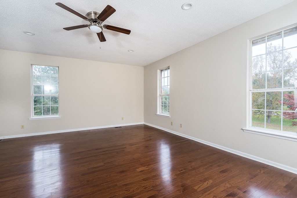 136 Gates Road Lizella, GA 31052 - Photo 14 of 29 a view of an empty room with wooden floor and a window