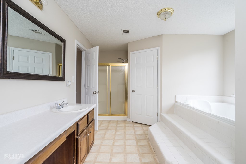 136 Gates Road Lizella, GA 31052 - Photo 22 of 29 a spacious bathroom with a bathtub sink and mirror