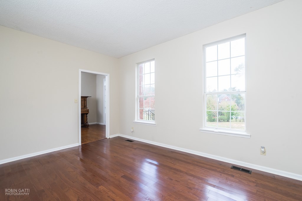 136 Gates Road Lizella, GA 31052 - Photo 5 of 29 an empty room with wooden floor and windows