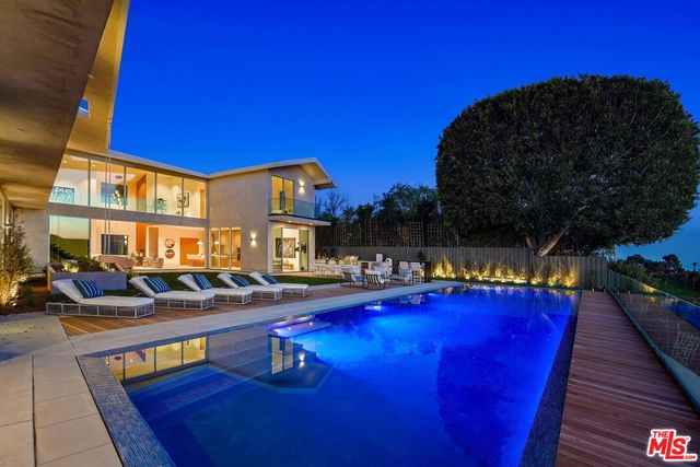 a dining table with chairs and kitchen view