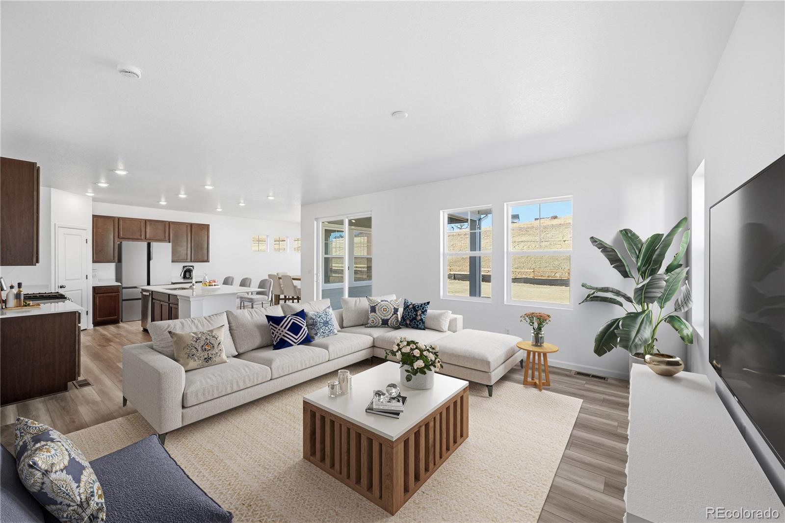 39803 Penn Road Elizabeth, CO 80107 - Photo 2 of 43 a living room with furniture a wooden floor and a large window