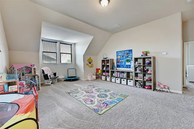 a living room with furniture toys and a book shelf