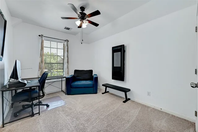 a view of a livingroom with workspace and a window