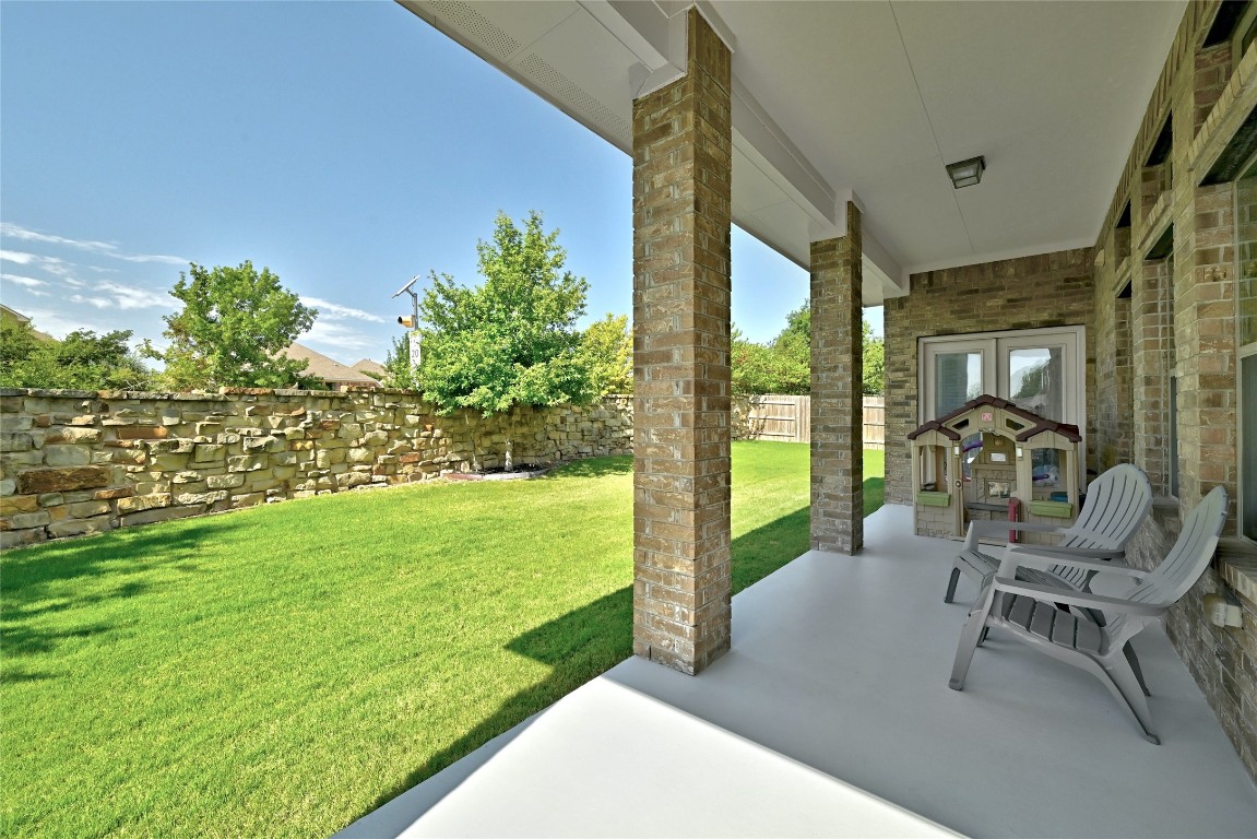 2812 St Paul Rivera Round Rock, TX 78665 - Photo 18 of 28 a view of a patio with table and chairs potted plants and floor to ceiling window