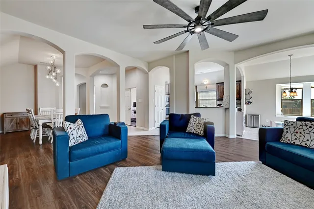 a living room with furniture and a chandelier